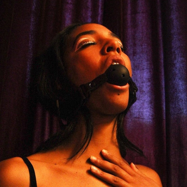 Model wearing black ball gag