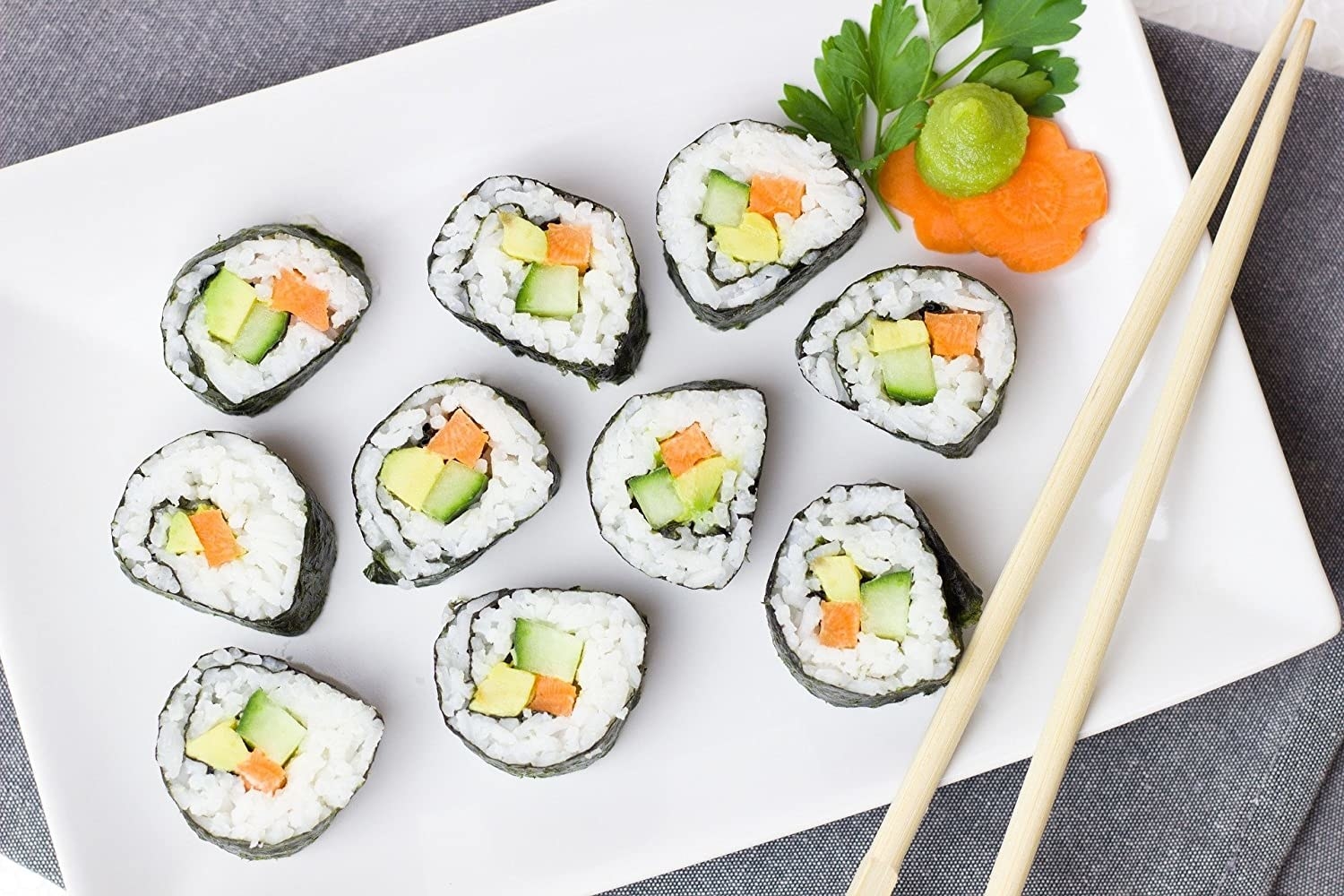 A plate of sushi with chopsticks