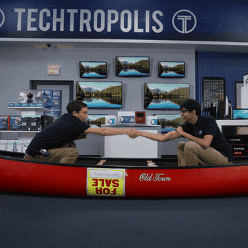 GIF of Zahid and Sam shaking hands while sitting in a canoe on the job