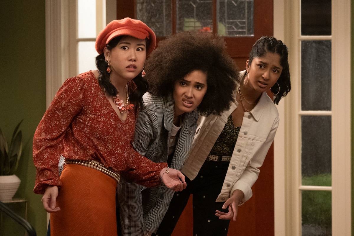 Eleanor, Fabiola, and Devi peaking their head into the living room to spy