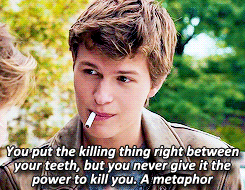 Augustus in the Fault in Our Stars puts cigarette between his teeth