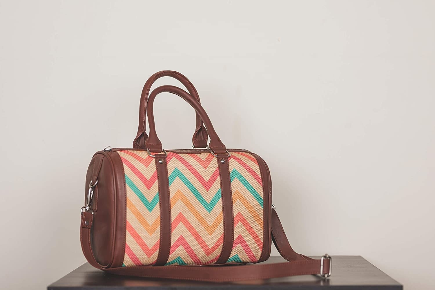 The handmade has brown straps and a colourful zigzag design on its body