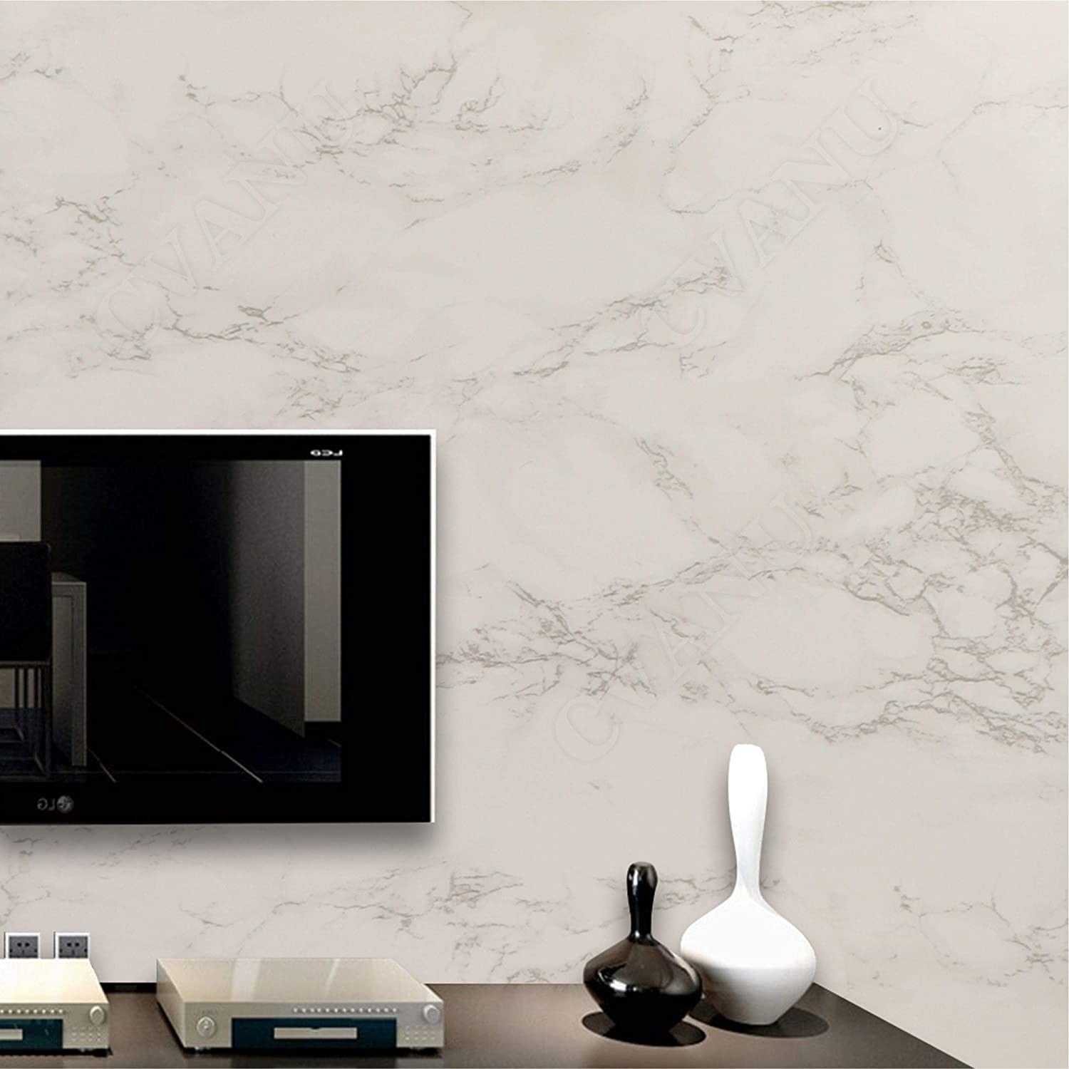 Cream coloured wallpaper with a marble finished on a wall behind a television