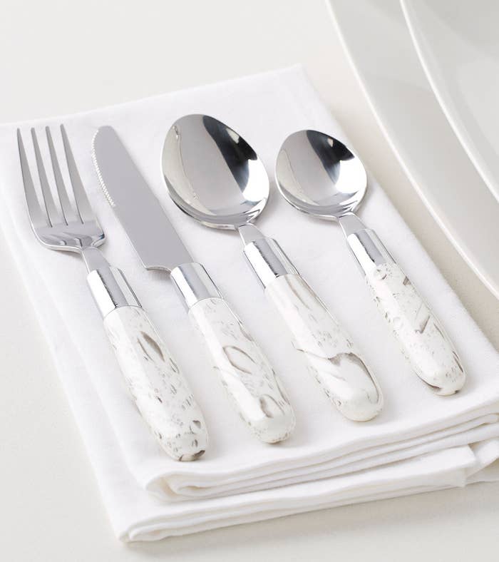 fork, knife, and two spoons on a linen