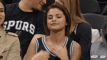 Selena Gomez flaunting her jersey at a game