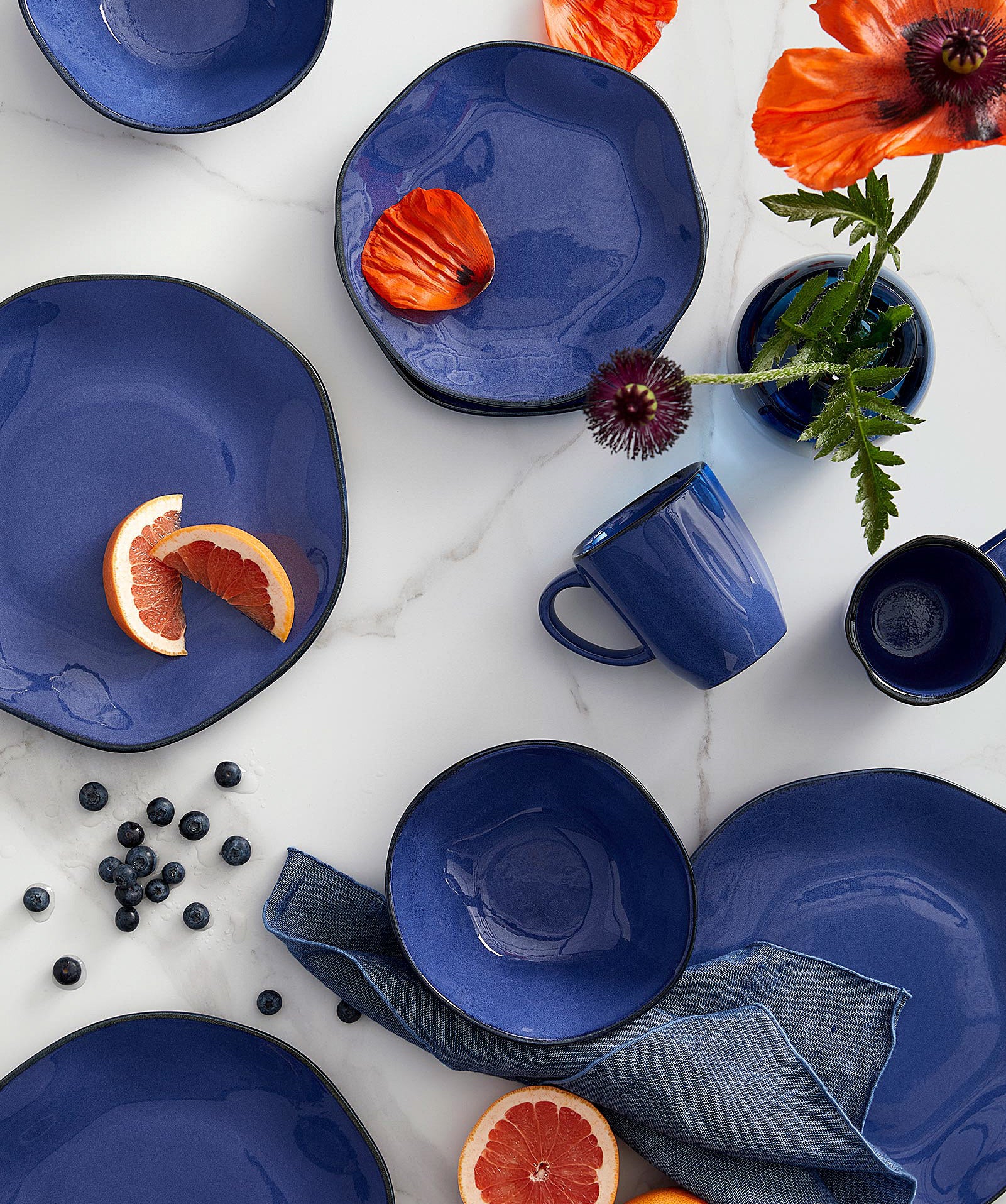 various plates and fruit slices on a marble table