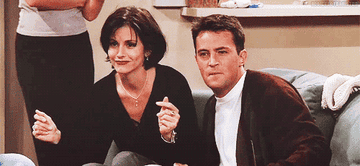 Chandler and Monica dancing on a couch