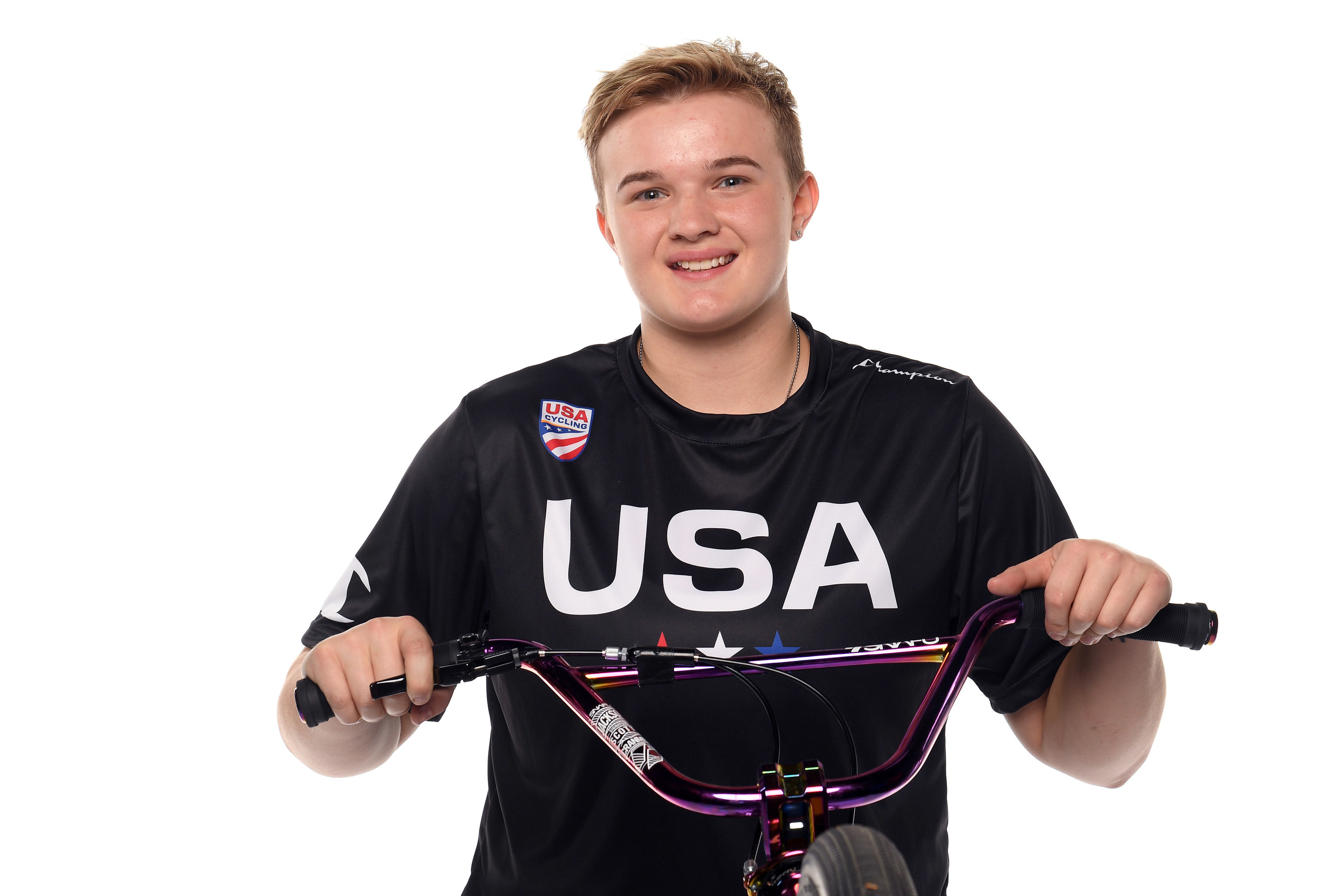 Hannah wearing a team usa shirt and posing with her bike