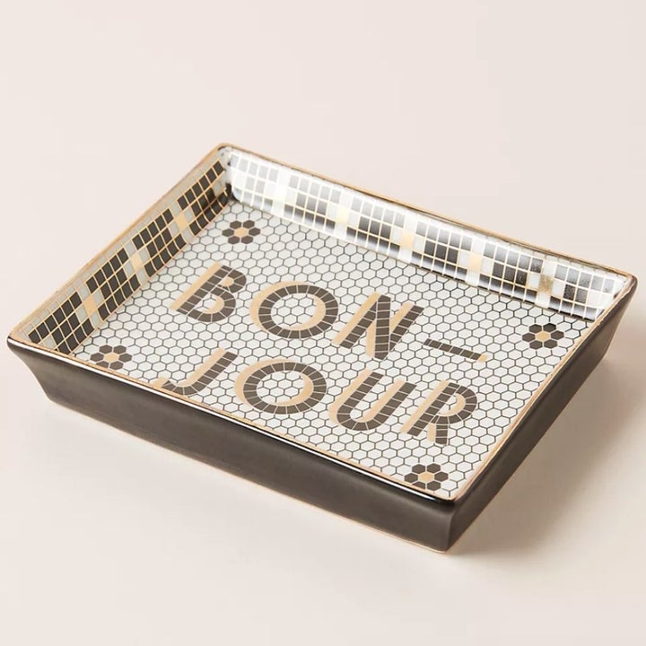 A stoneware, bistro-style vanity tray that has "Bon-Jour" written in tiles on the face