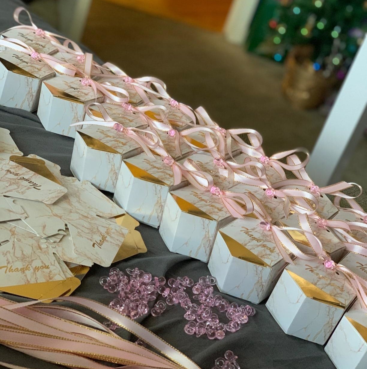 Reviewer photo of the marbled cardboard gift boxes with pink ribbon on top