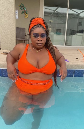 reviewer wearing the orange set