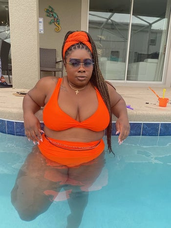 reviewer wearing the orange set