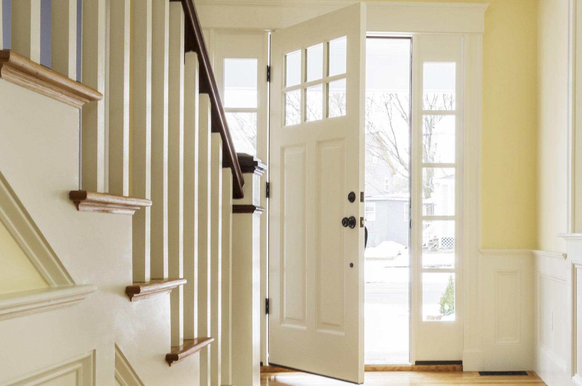 The inside of a foyer with the front door open