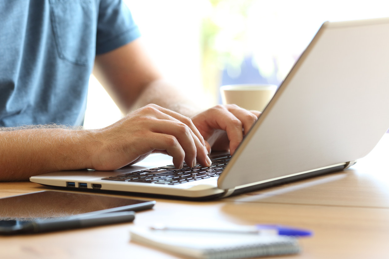 A person looking up information on a laptop