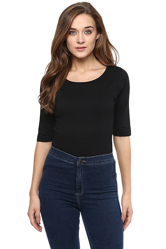 A woman wearing a black bodysuit with jeans