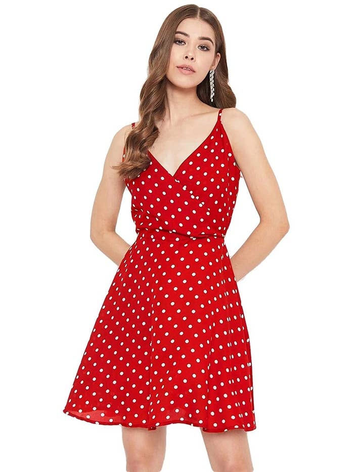 Woman wearing fit and flare short dress in red with white polka dots