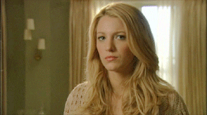 A close up of Serena van der Woodsen as she purses her lips before smiling