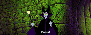 Maleficent yelling fools while purple light flashes around her