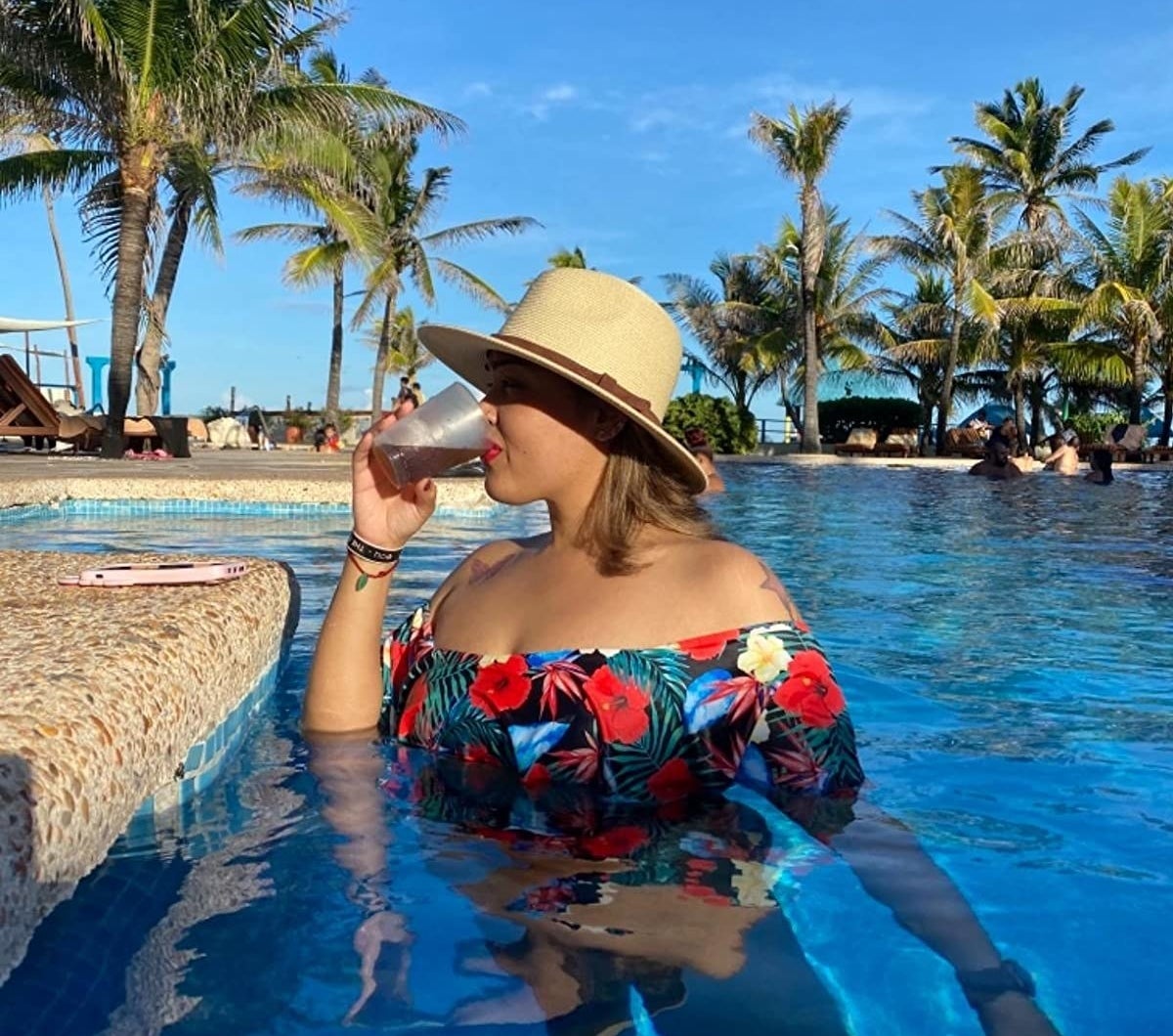 reviewer wearing the straw panama hat