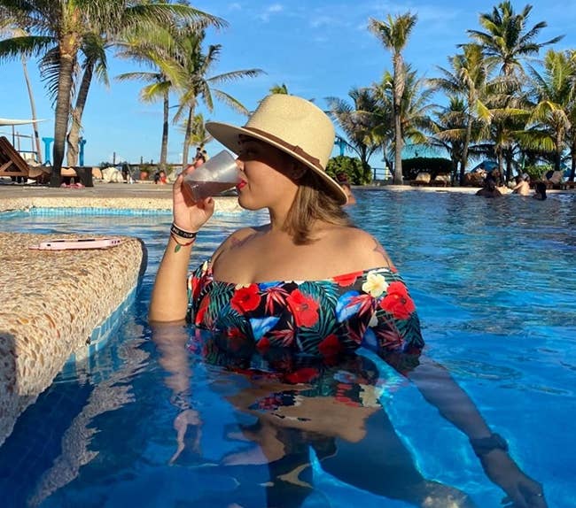 reviewer wearing the straw panama hat