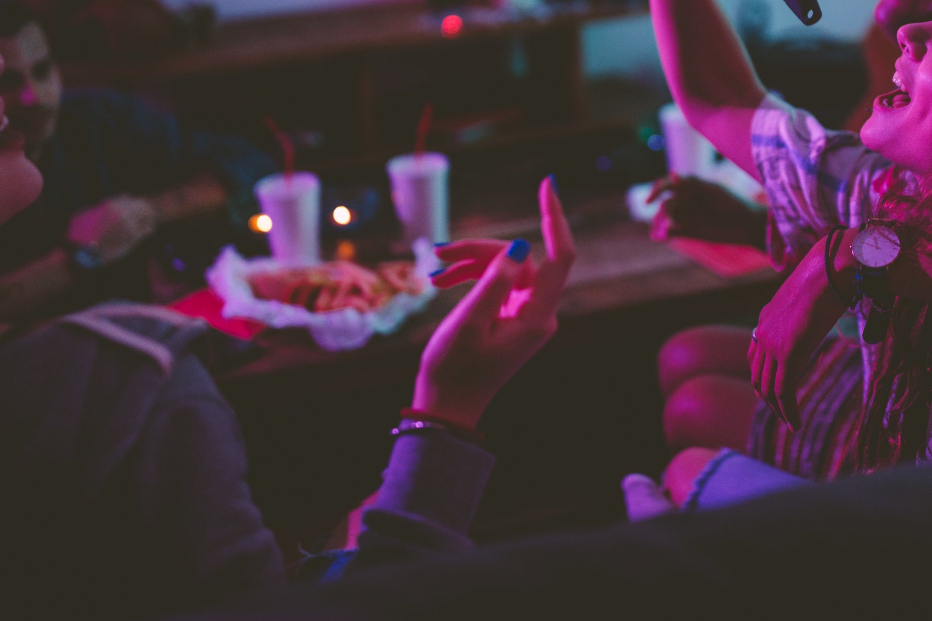 A group of people sitting on a couch at a party