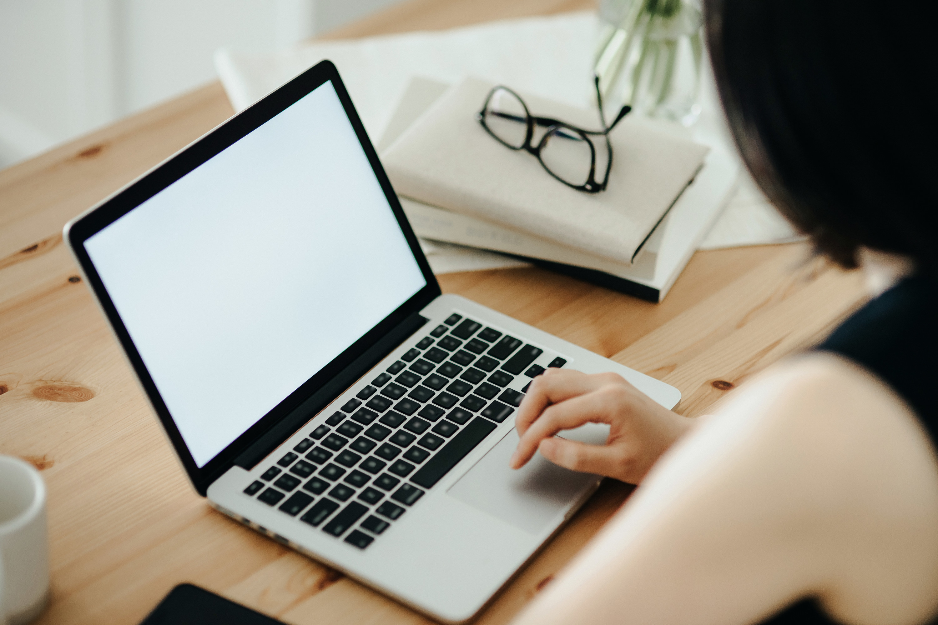 A person on their laptop sitting at a desk