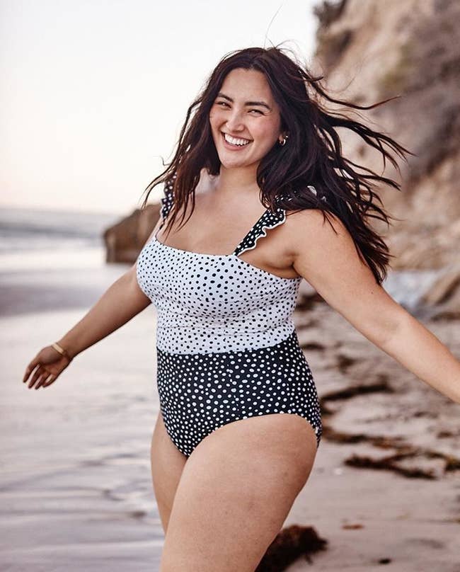 model wearing the white and black polka dot contrast swimsuit