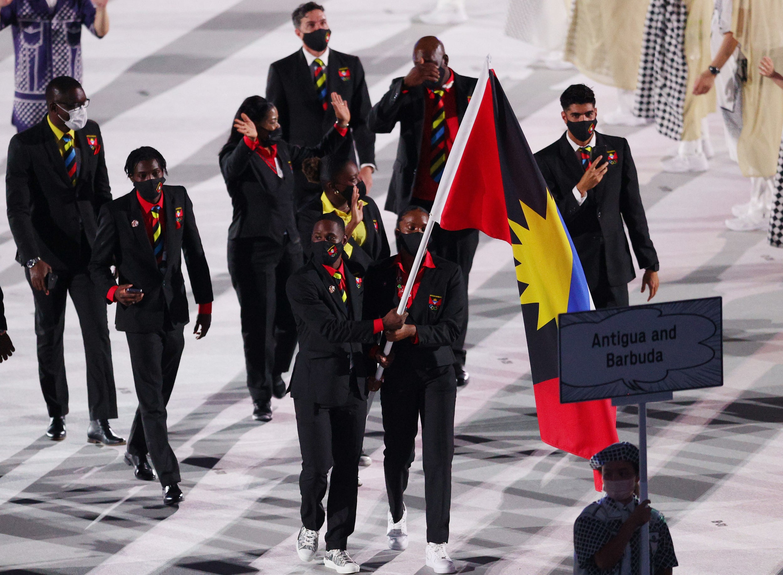 The athletes wore dark suits with ties and shirts that match the colors of their flag