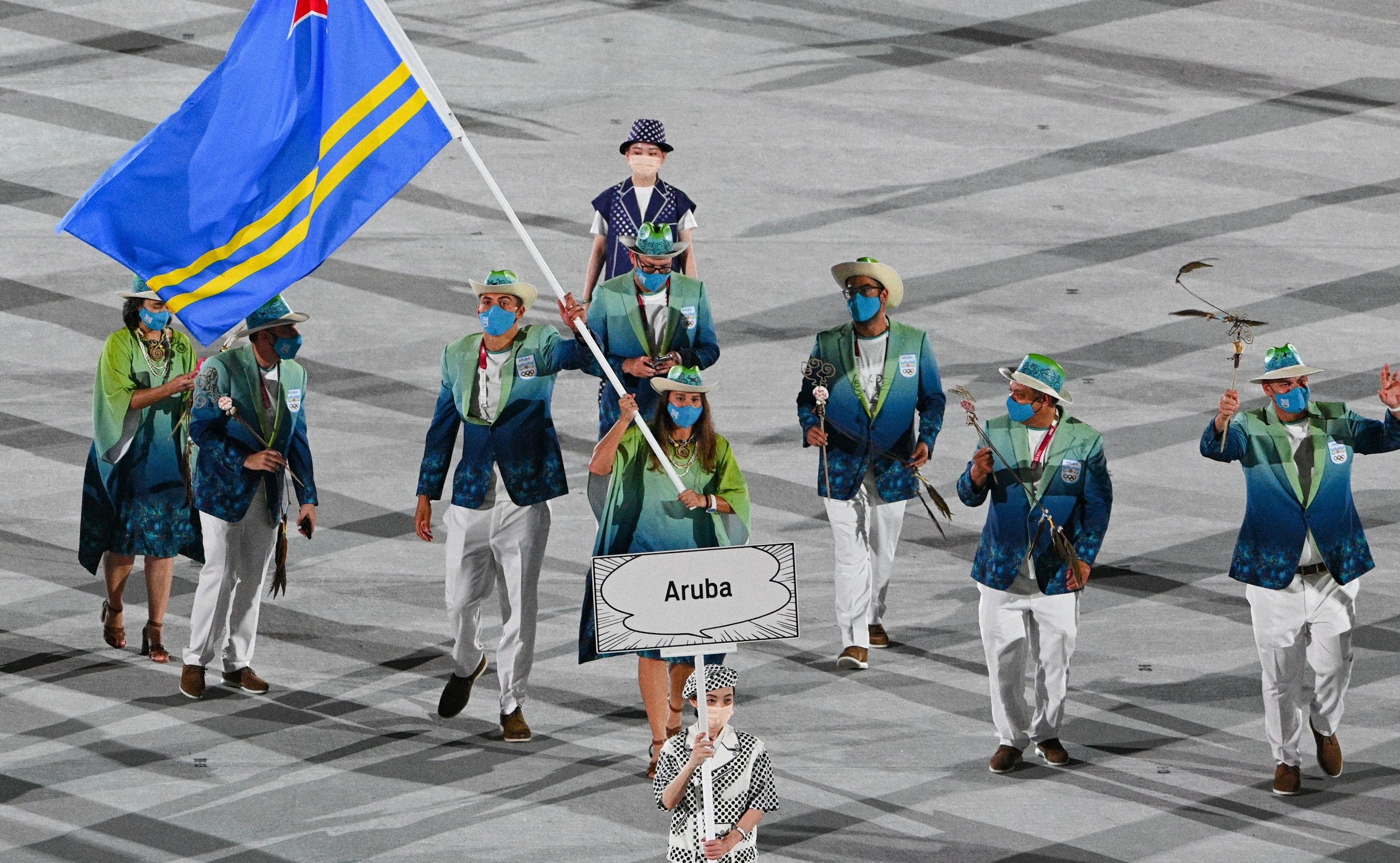 The athletes wore multi-colored blazers and light pants or dark skirts