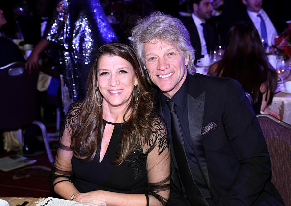 Dorothea and Jon smiling and sitting together at a formal event