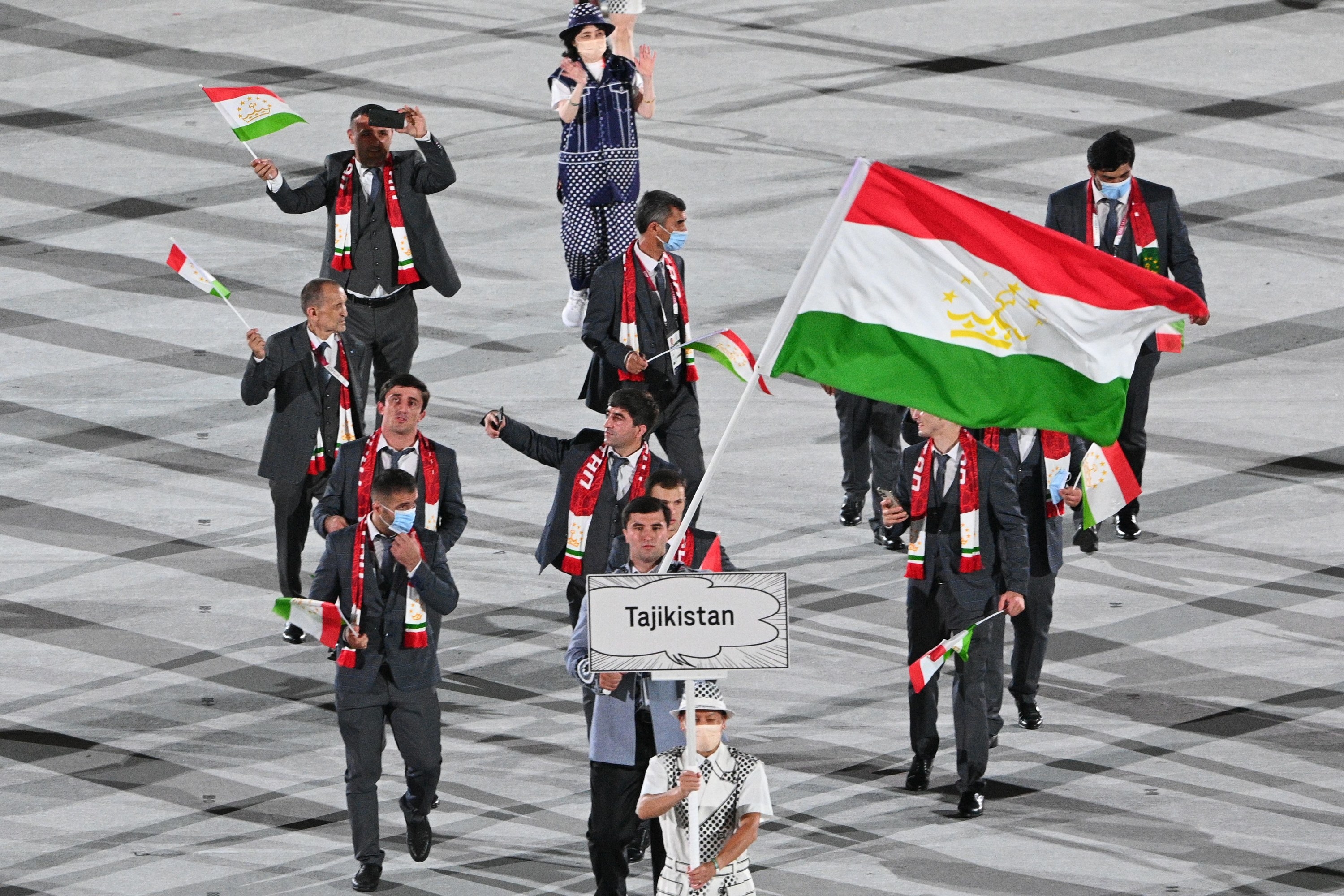 The athletes wore suits and scarves that matched the colors of their flag