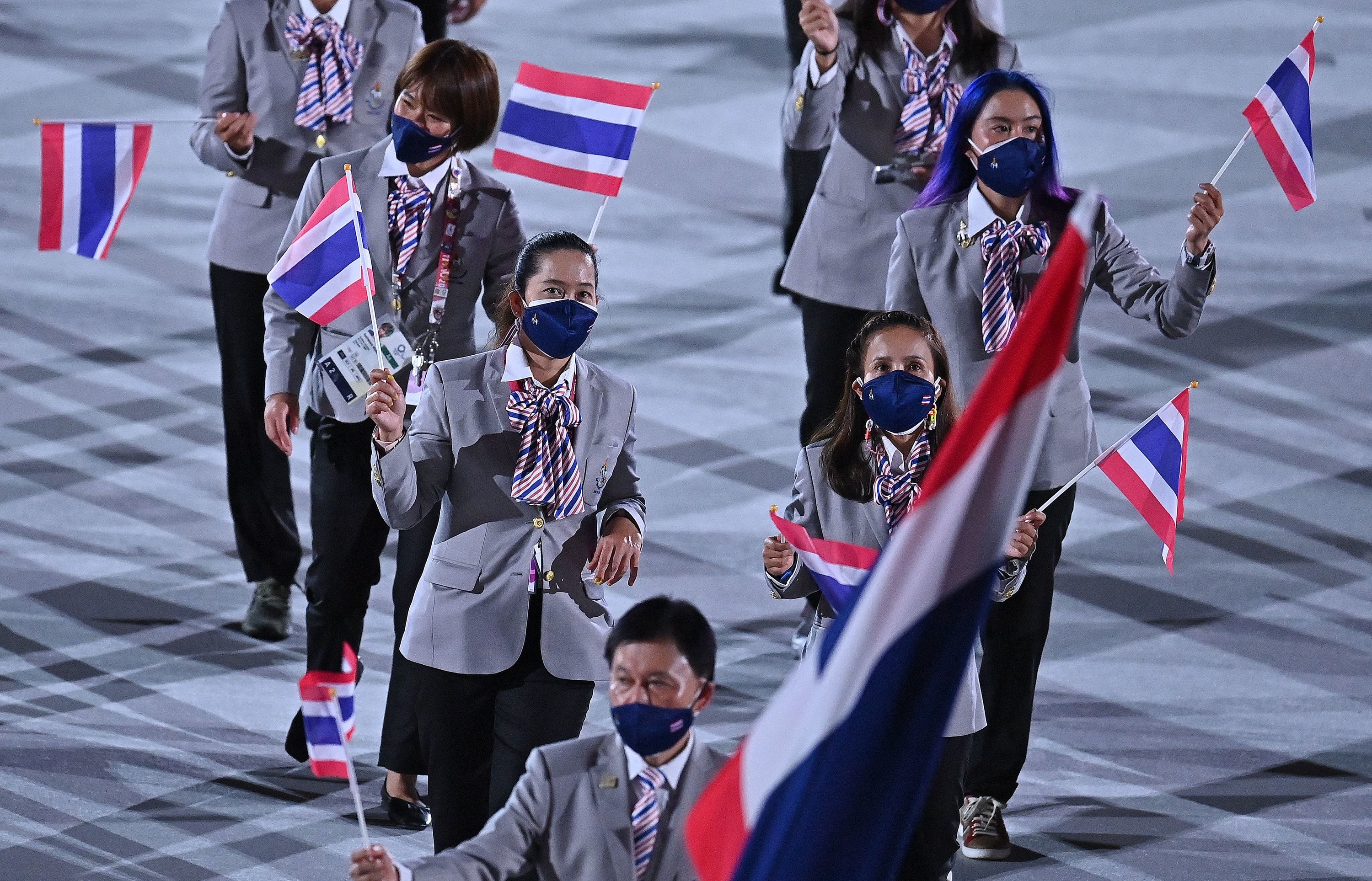 The athletes wore suits and matching ties neck scarves