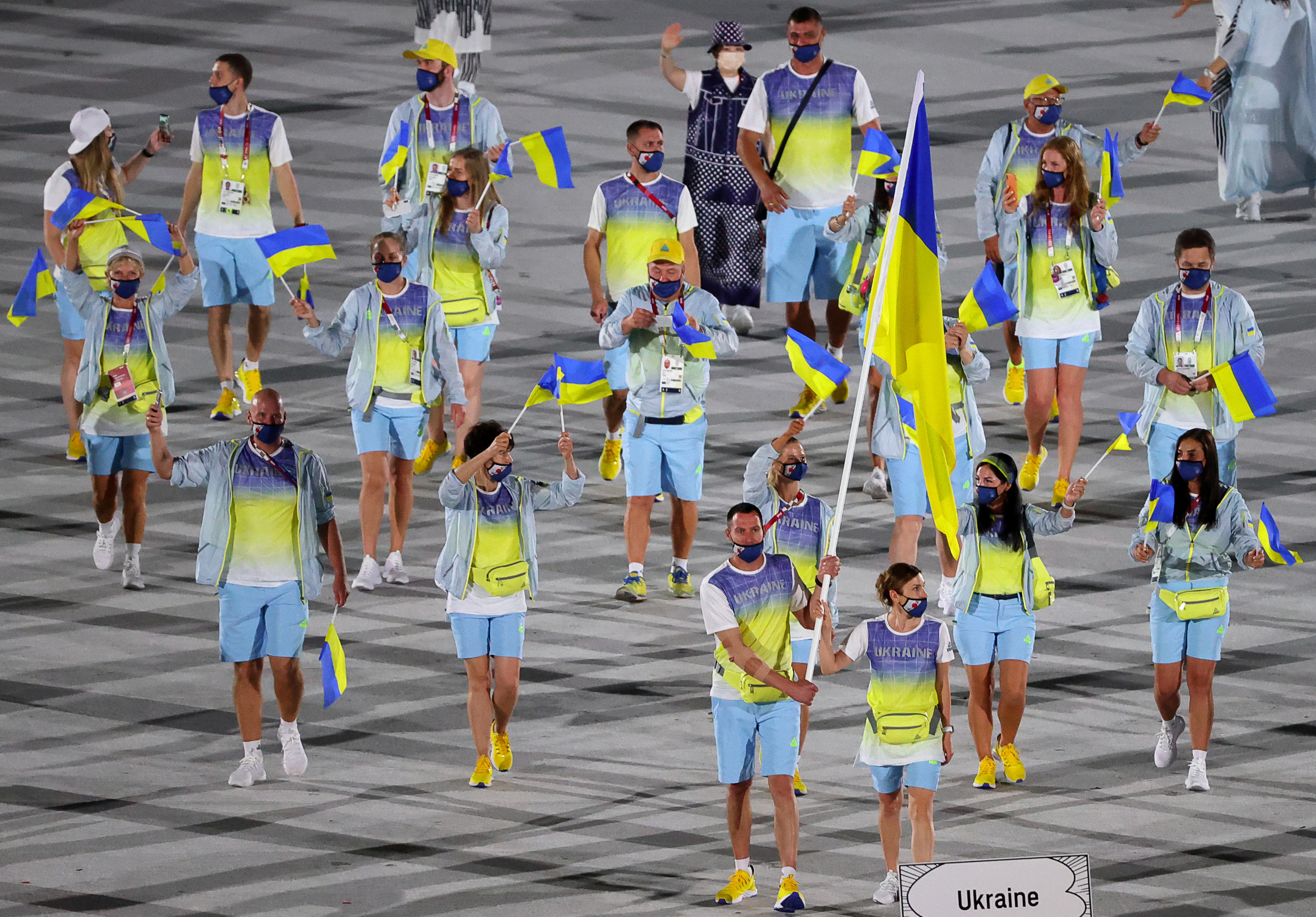 The athletes wore multicolored shirts with matching shorts that reflected the colors of their flags