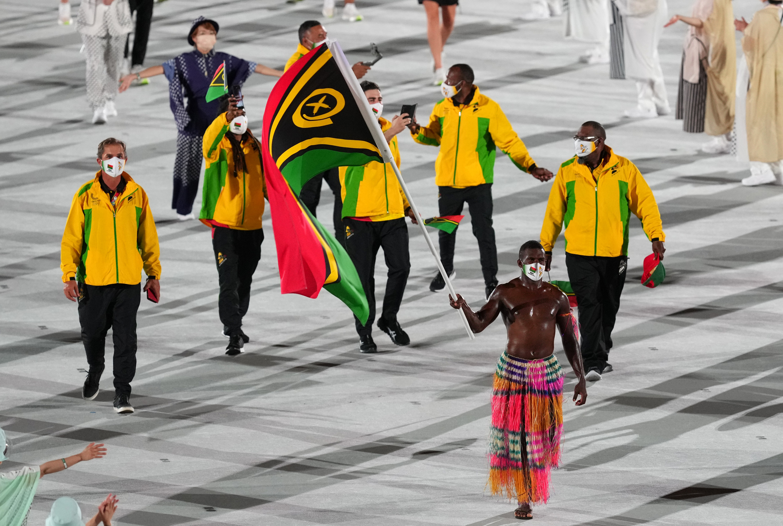 The athletes wore multi-colored tracksuits with the flag bearer wearing a traditional woven skirt