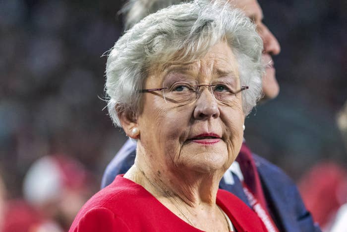 Kay Ivey is shown wearing glasses and looking off-camera