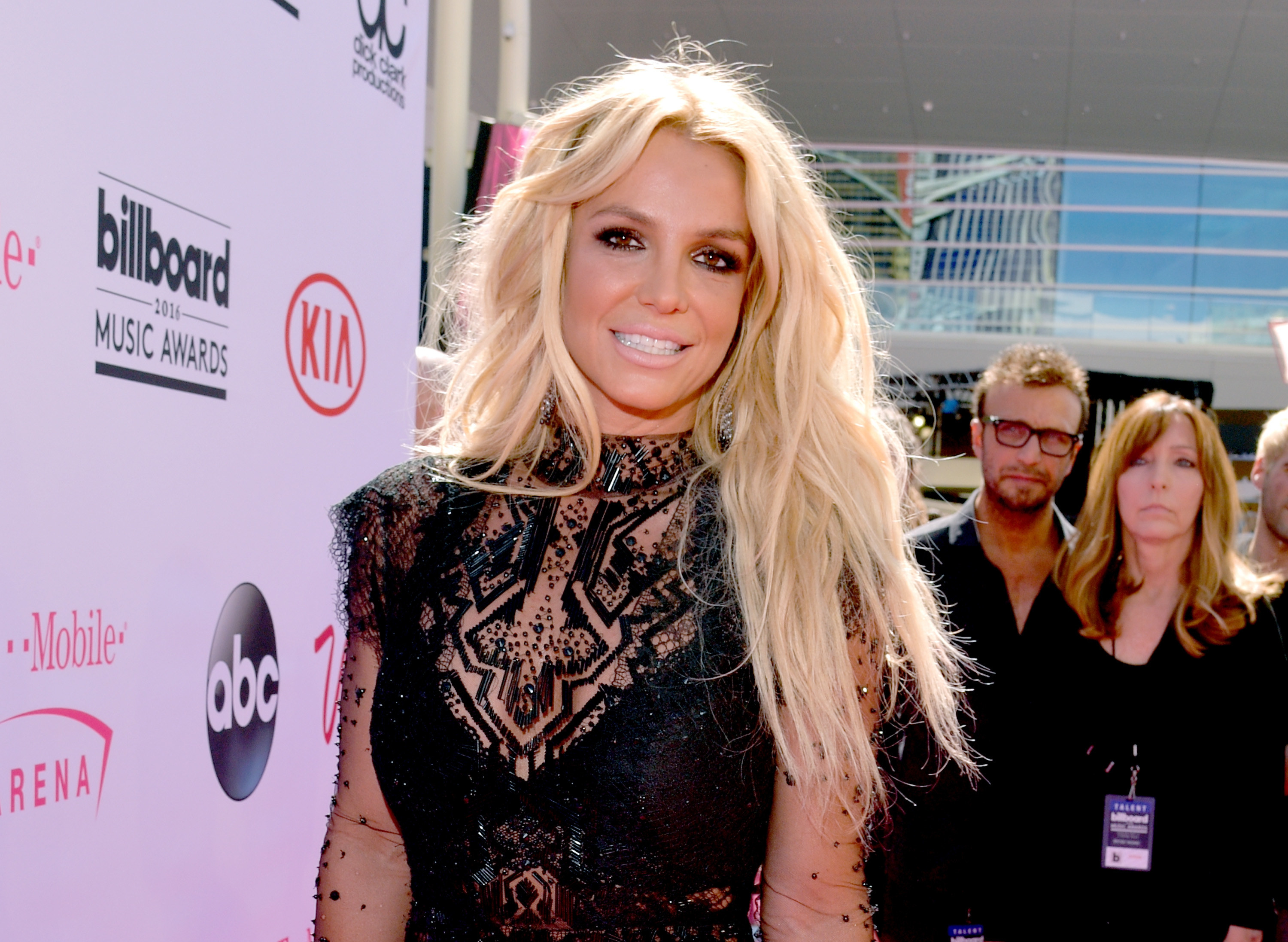 Spears smiles while wearing a cut-out dress at a red carpet event