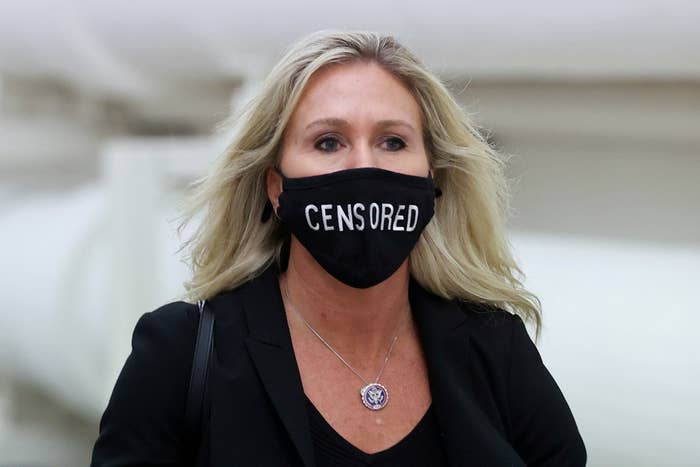 Marjorie Taylor Greene wearing a mask that says censored on it