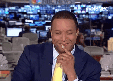 Craig Melvin smirks and blinks with his finger to his lip