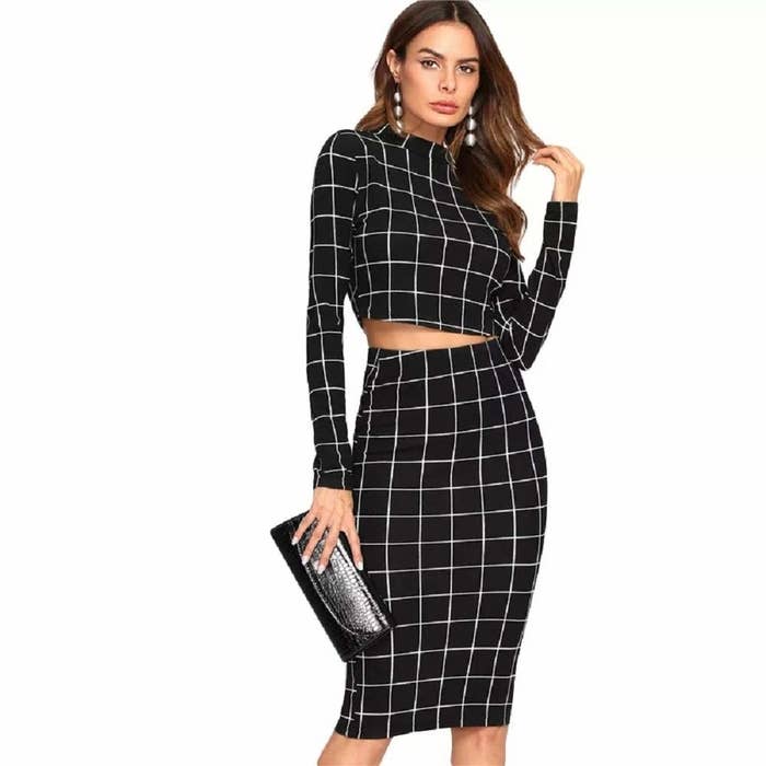 A woman wearing a grid print top and pencil skirt in black