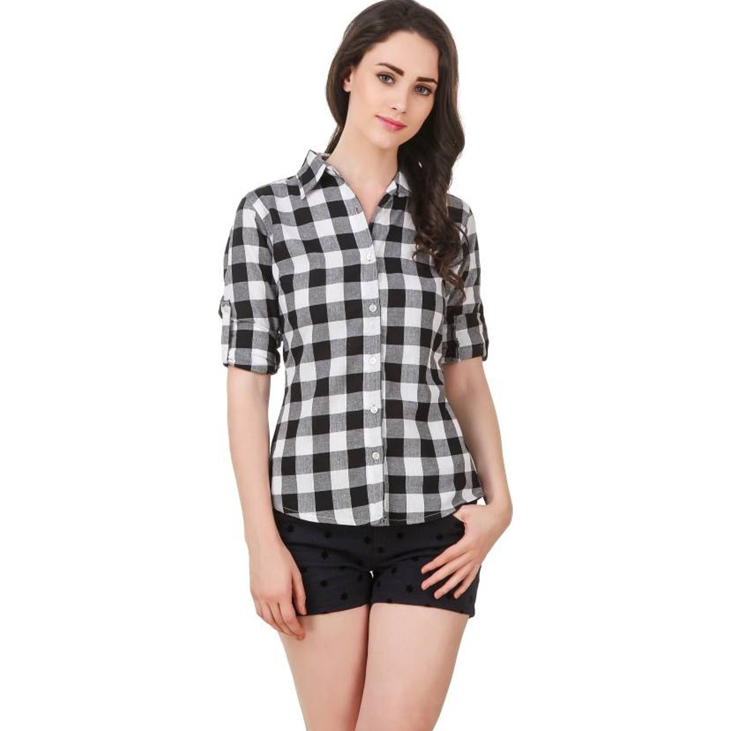 A woman wearing black and white flannel shirt with shorts