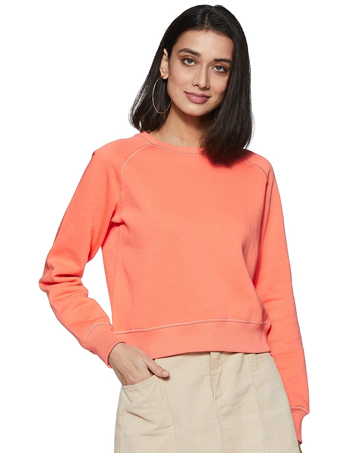 A woman wearing short sweatshirt in orange