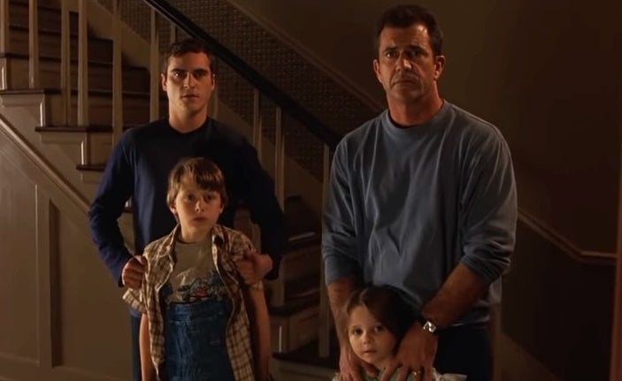 Joaquin Phoenix, Mel Gibson, and family look contemplatively at the camera