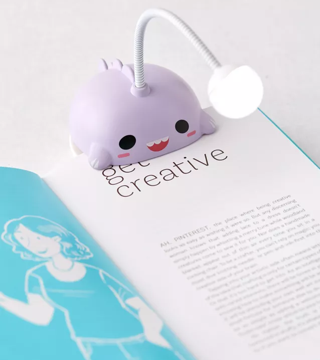 A small book light attached to the top of a book