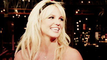 GIF of Britney with a headband and smiling broadly