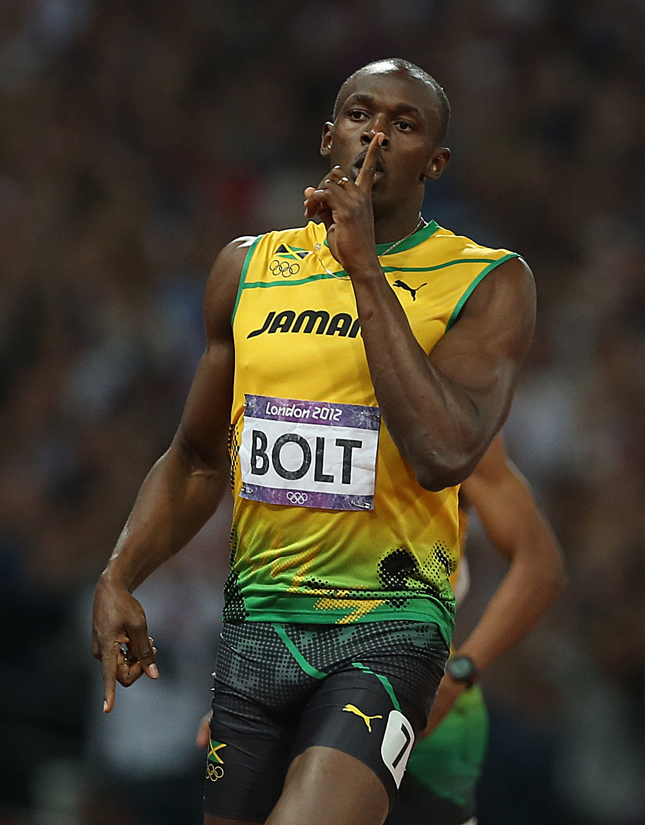 Usain Bolt celebrates after his race