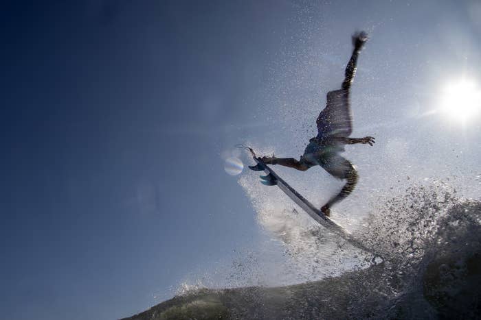 Italo surfing in midair, arms raised