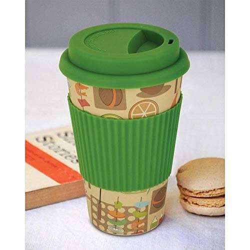 A beige mug with a green cap and silicone cover