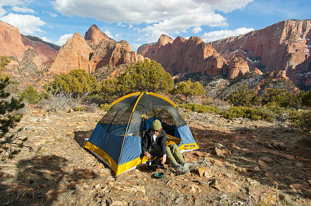 camper cooking in tent door