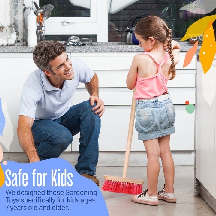 child with parent holding gardening tool 