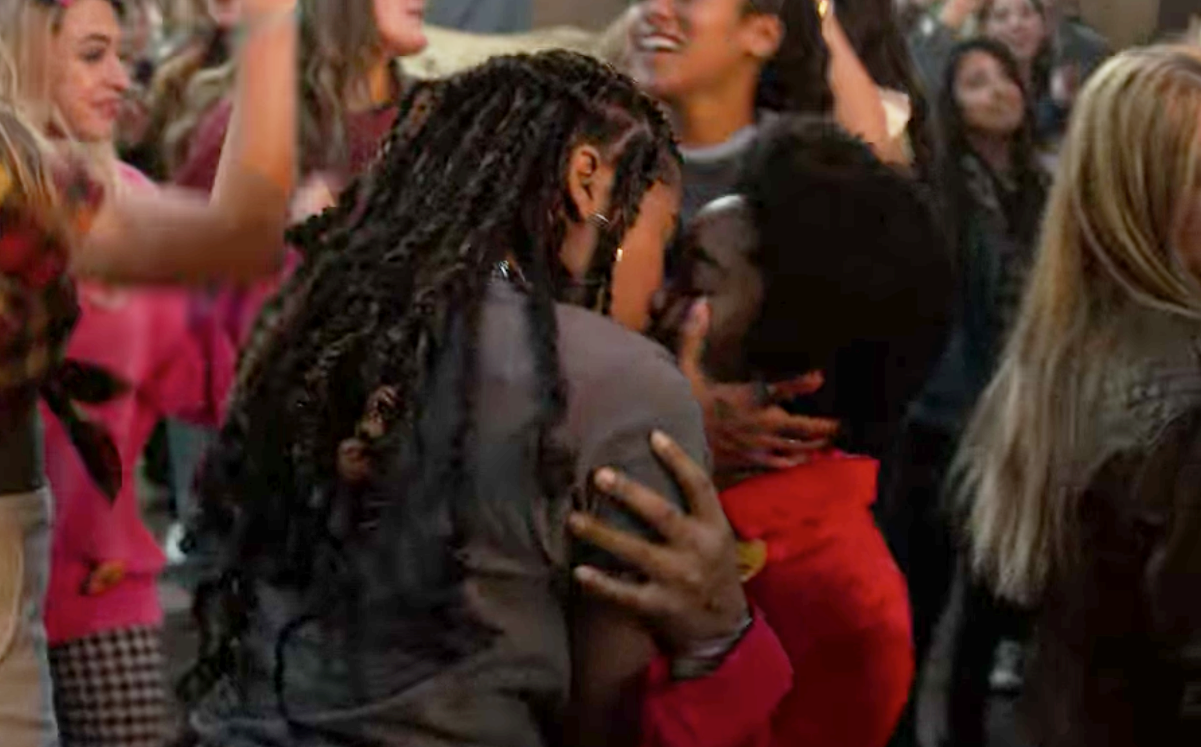 Lucy and Amaya kissing at a concert in the crowd